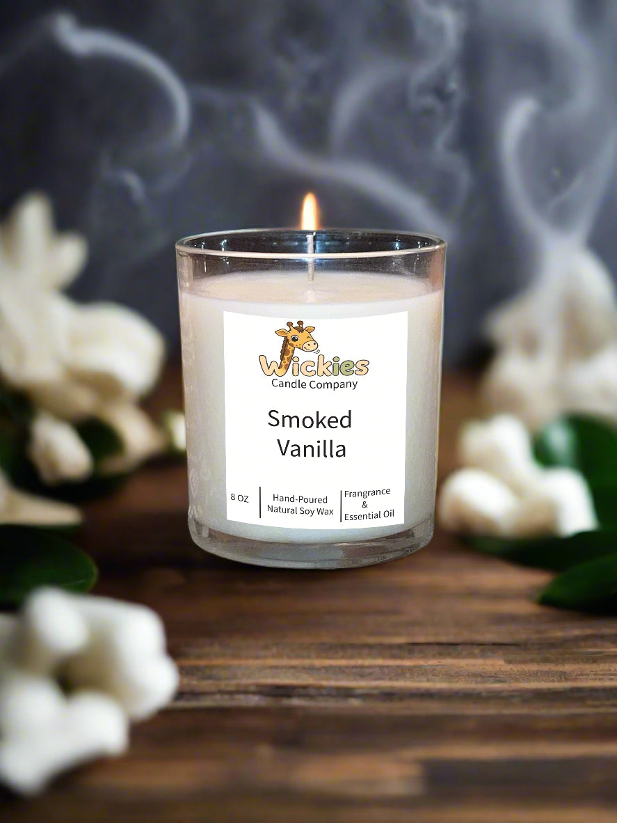 Candle labeled 'Smoked Vanilla' from Wickies Candle Company on a table with a textured surface.